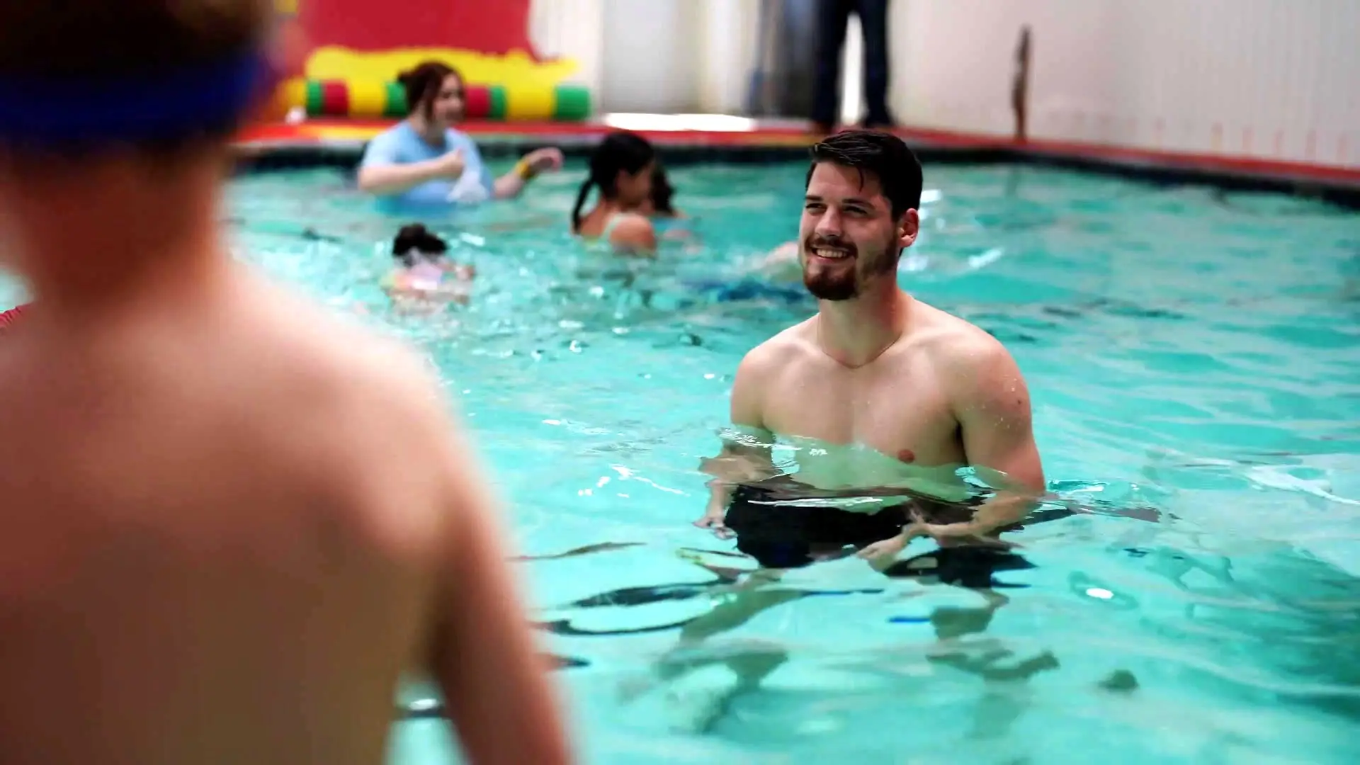 A coach observes a swimmer during focused private instruction